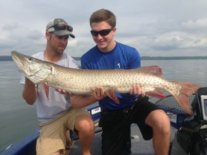 Mitchell and I hoist his first musky, a 50"er, after an exciting battle. She ate a Ripping Dawg.
