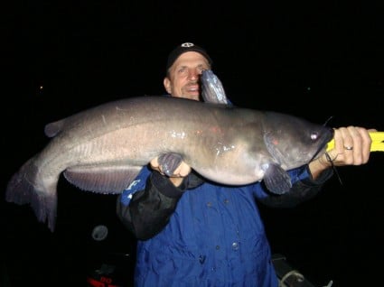 Sam's Father Mike, the Catfish Queen holding his big channel cat of the evening at 14+ pounds.